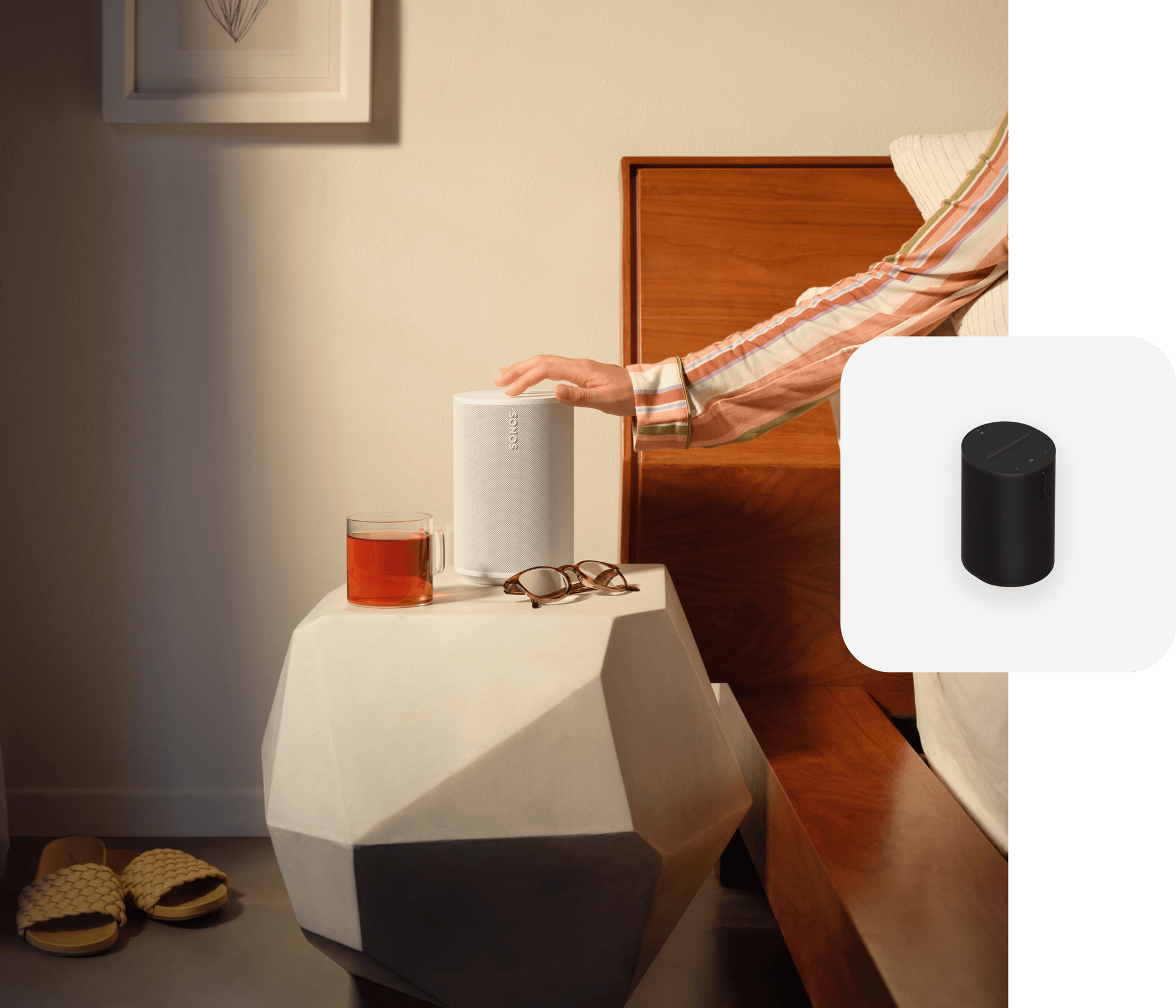 Hand touching a white Era 100 on a nightstand with black Era 100 product tile overlay