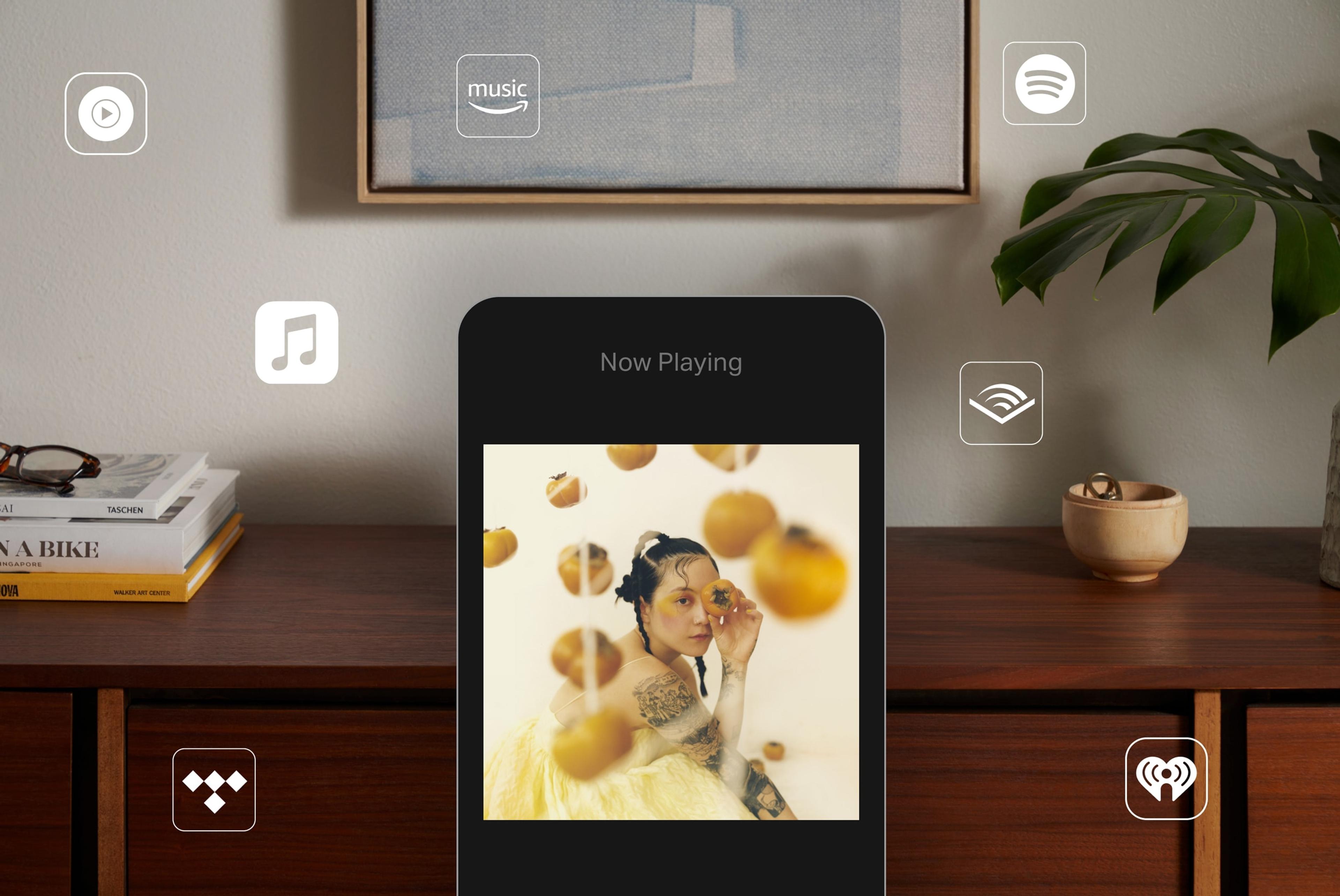 Image of a phone using Sonos app with various music streaming service logos