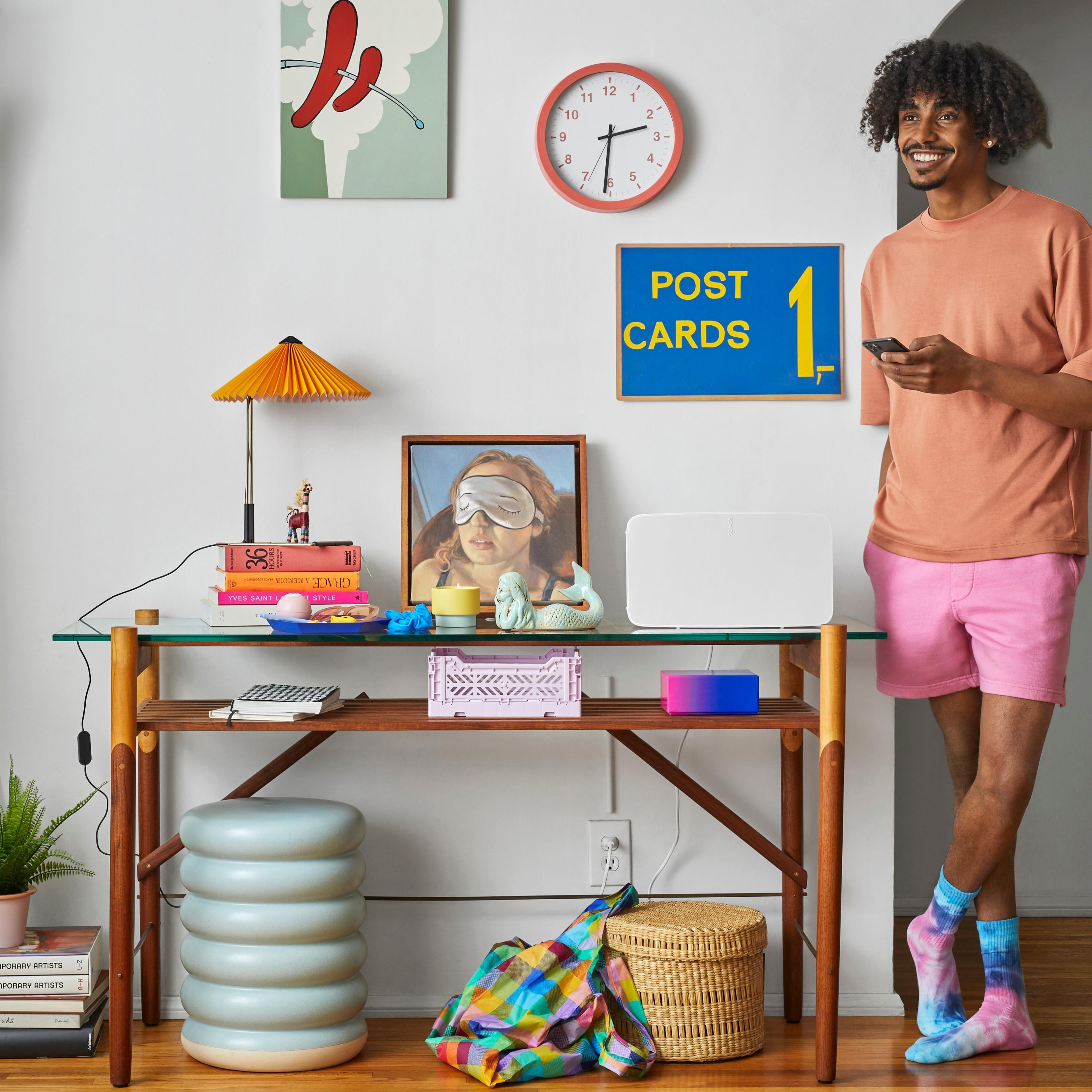 A Sonos user using his iPhone to control his Sonos system