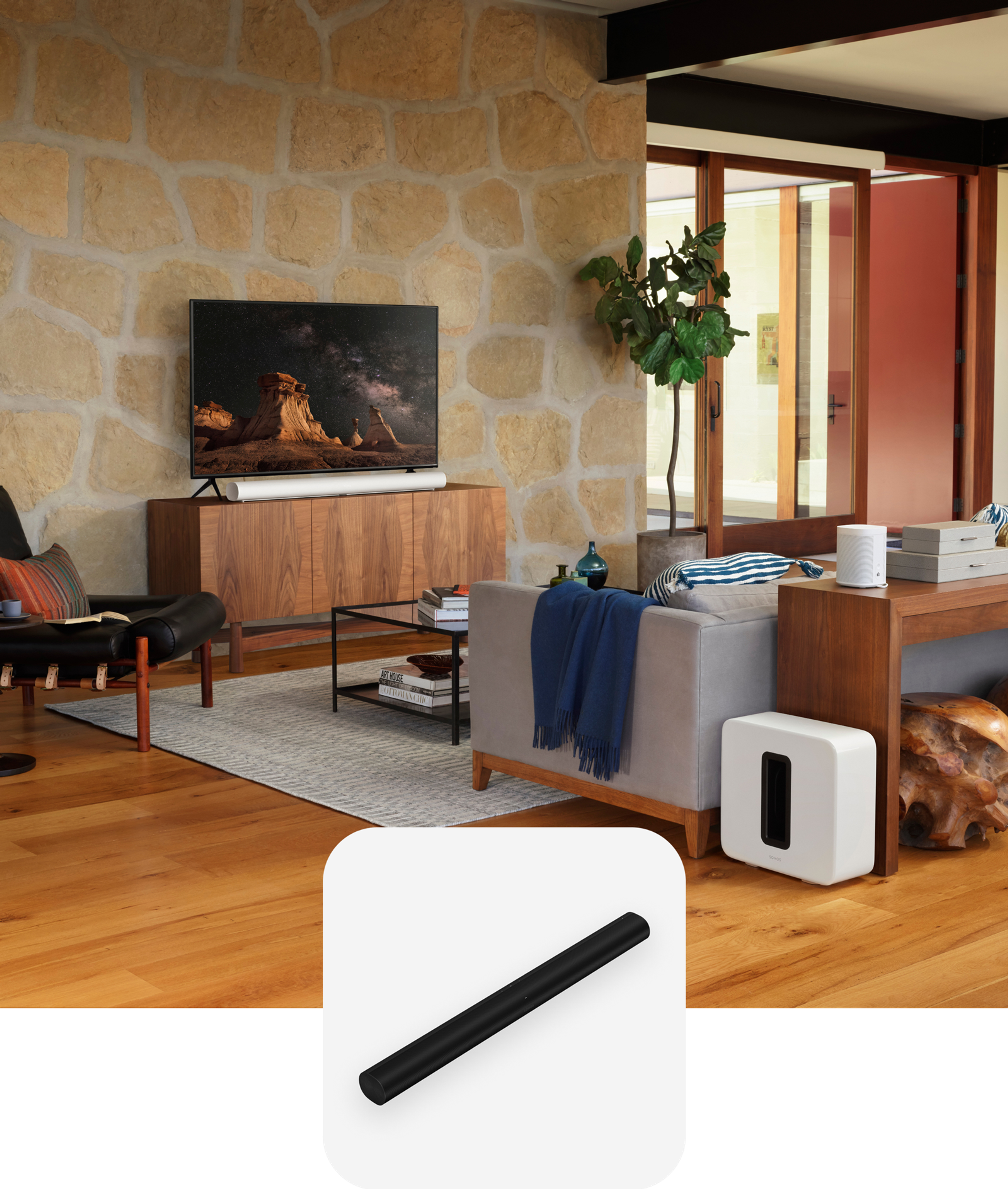 A home theater setup in a living room featuring white Sonos Arc, Sub, and two Era 100 speakers