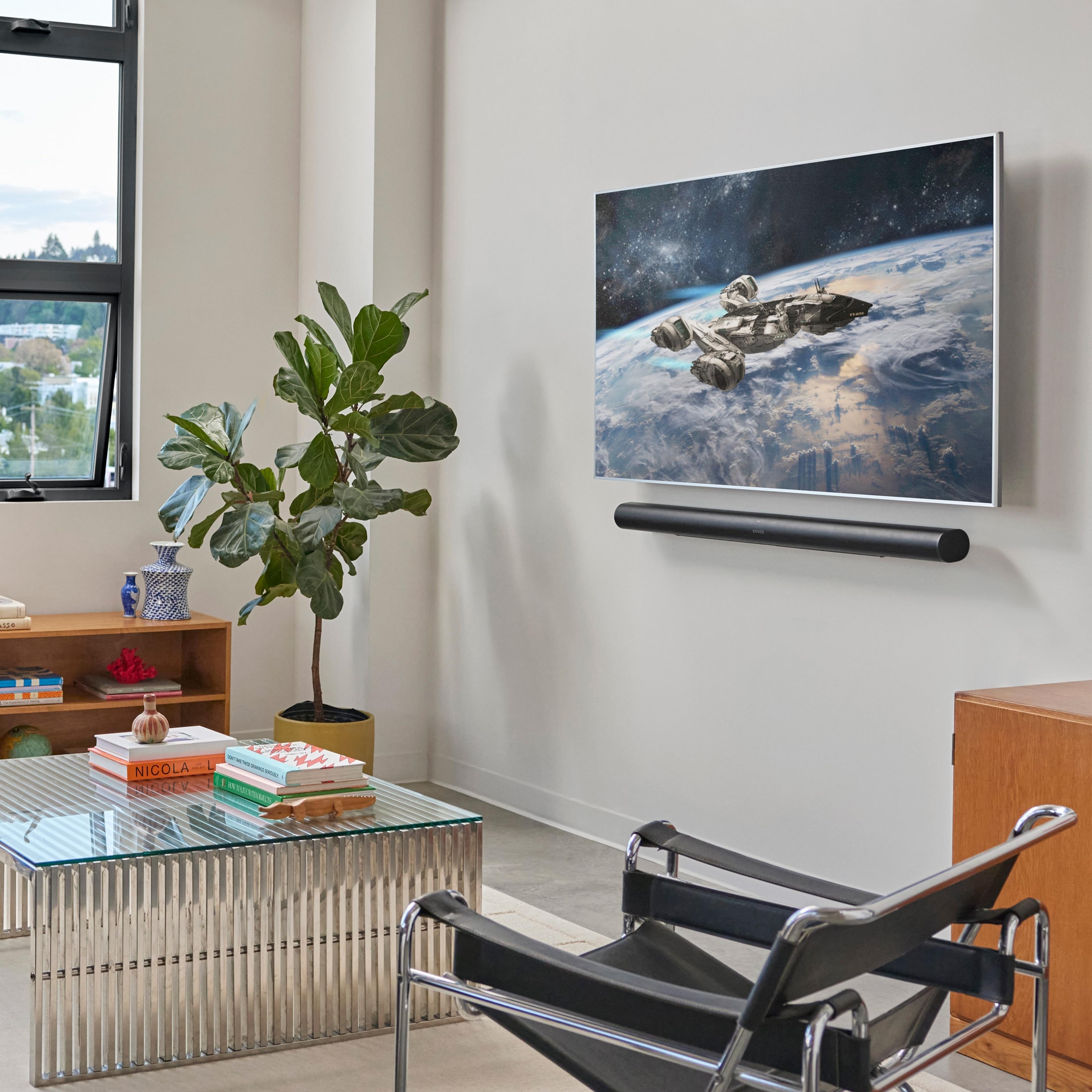 A black Arc Ultra mounted to the wall beneath a TV in a living room