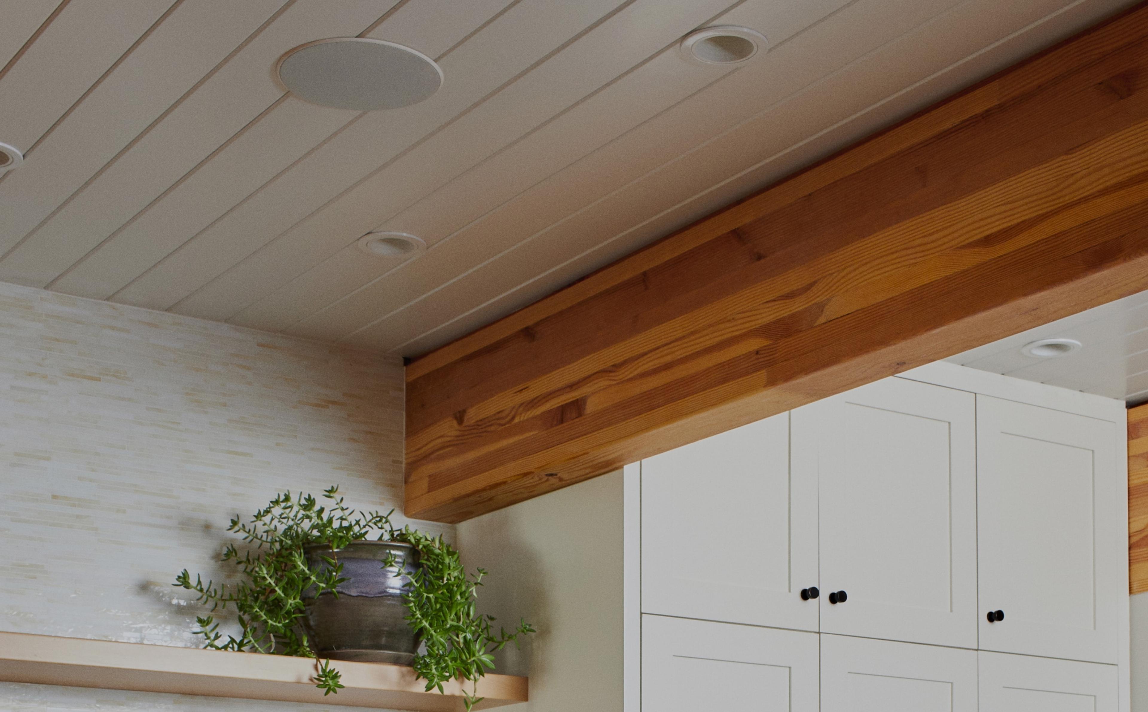 Closeup of Sonos and Sonance In-Ceiling speaker installed in ceiling above shelving