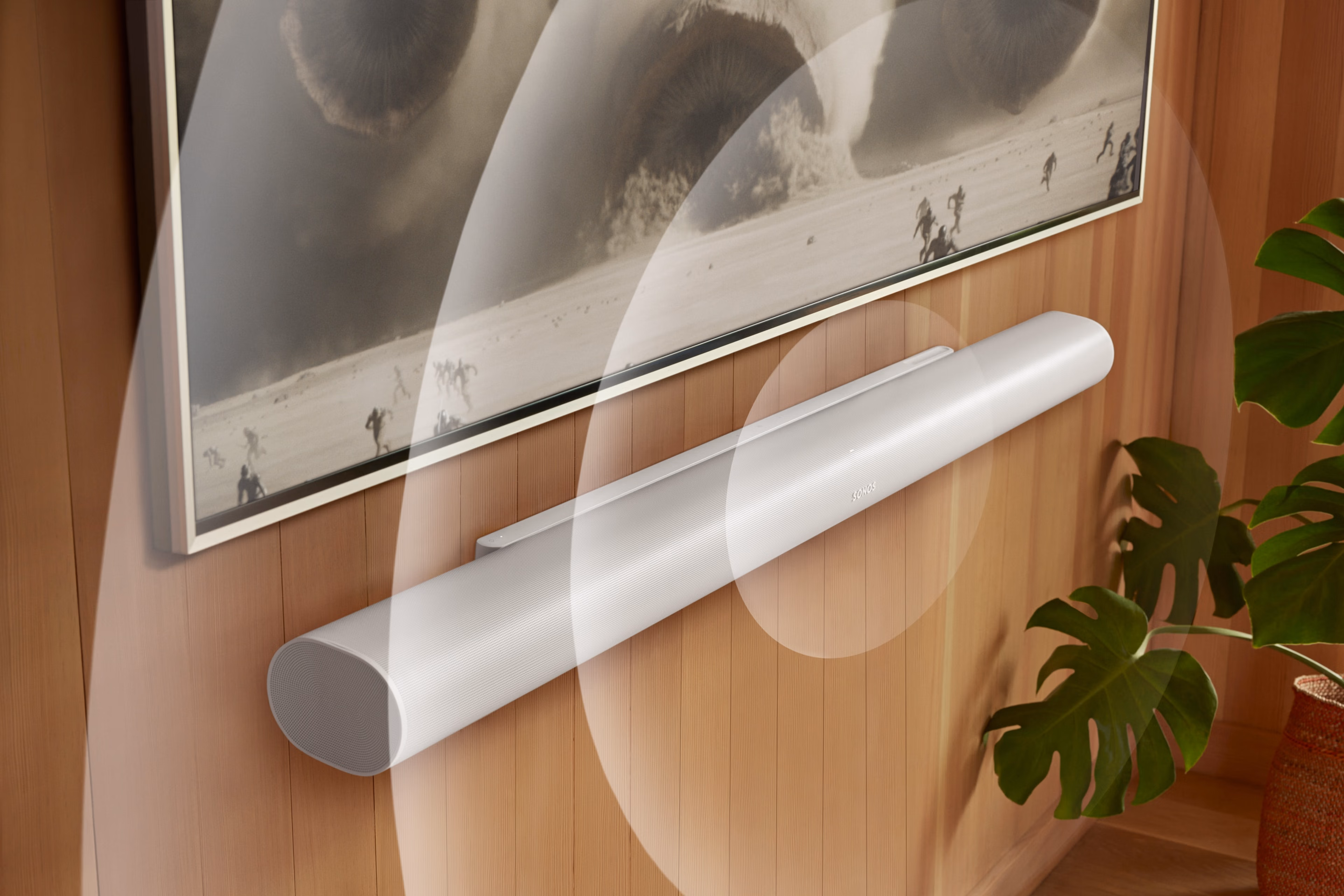 A white Arc Ultra mounted below a TV with animated sound waves and screen content from Dune 2
