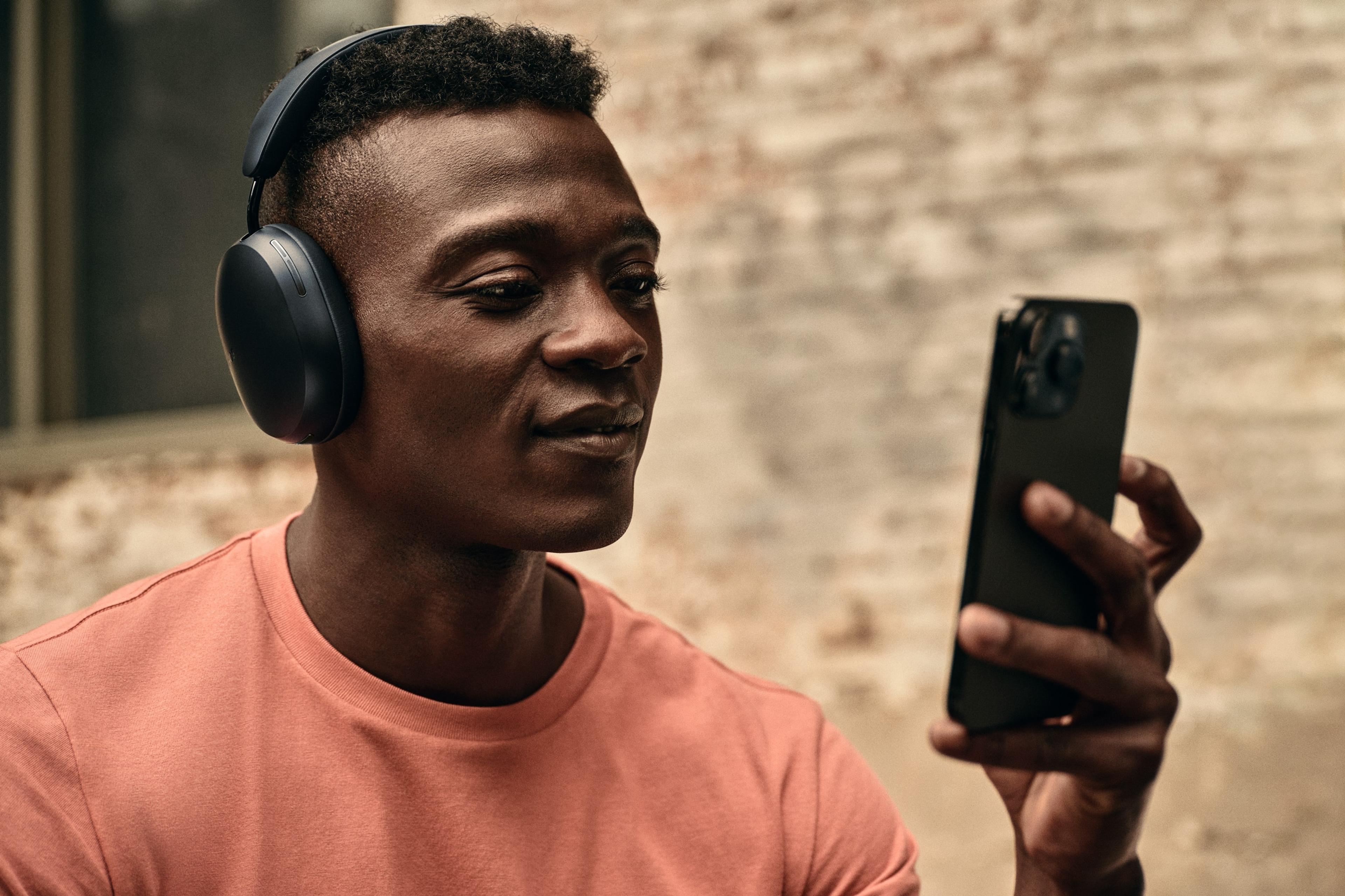 Person using Sonos Ace Headphones with their phone