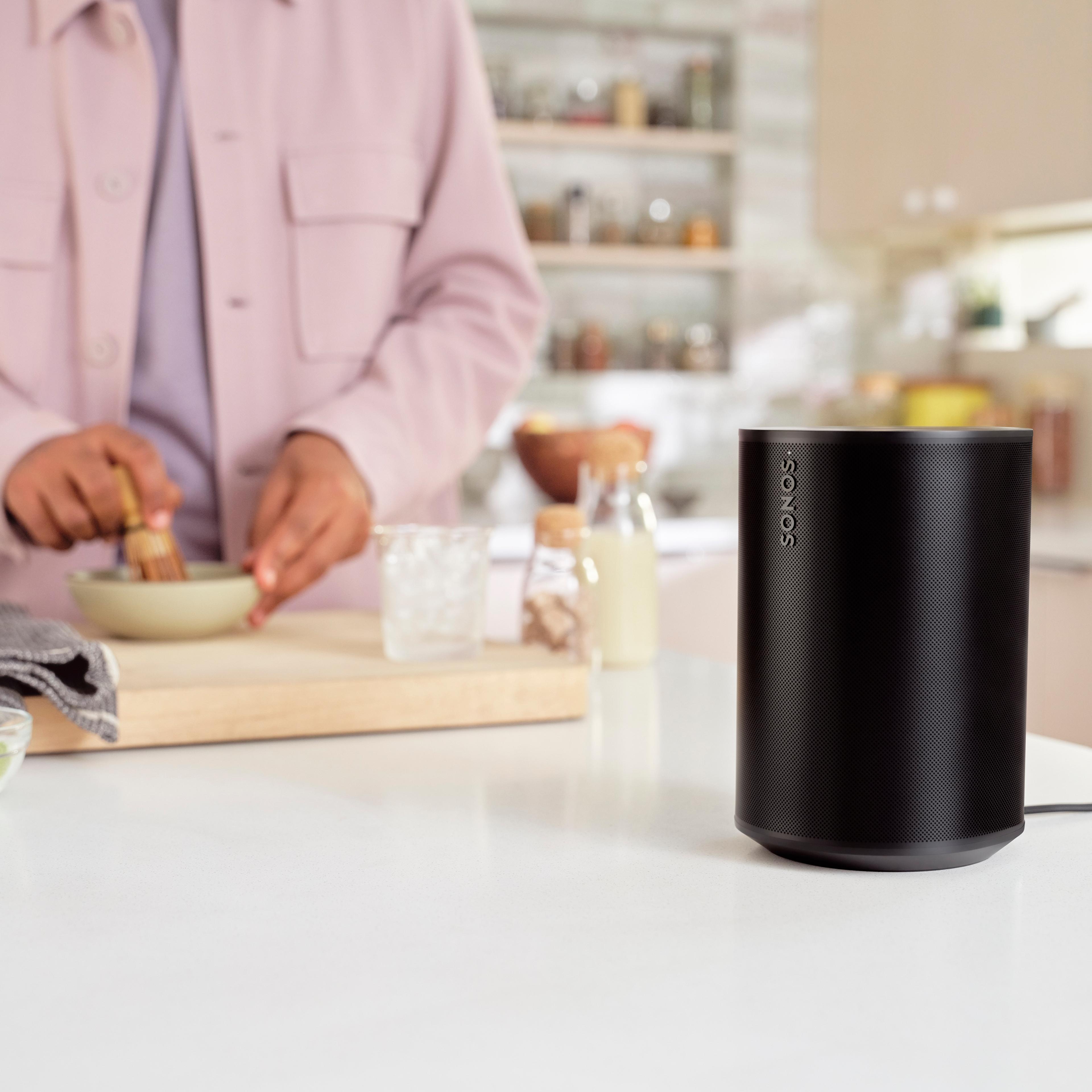 A black Sonos Era 100 sitting on a kitchen countertop